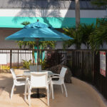 umbrella covered seating by the pool area